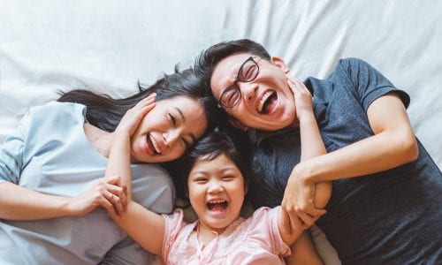 Happy family on a bed