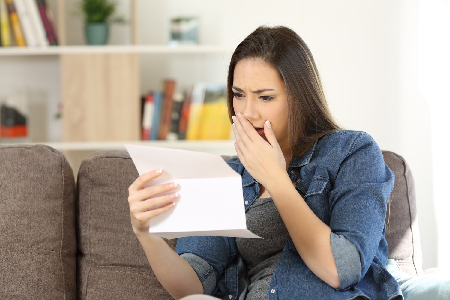 Woman gasps in shock after receiving a high energy bill